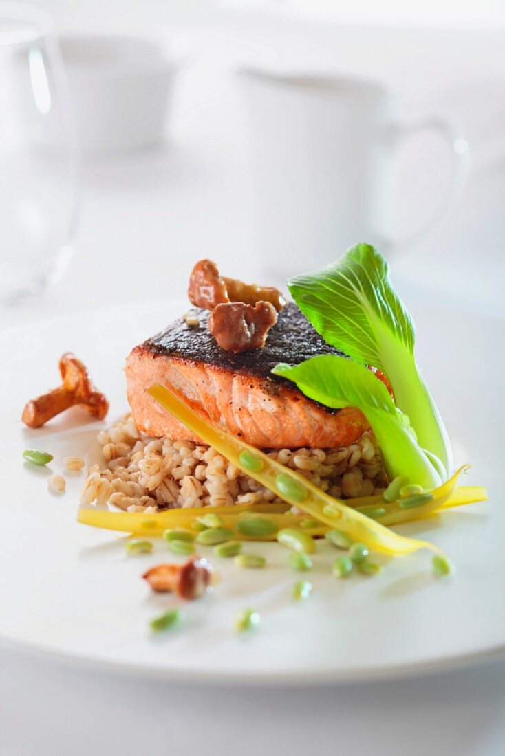 Salmon fillet with chanterelle mushrooms on a bed of barley