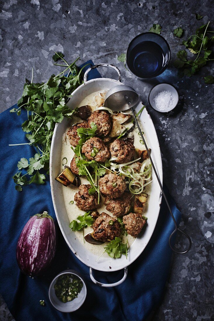 Meatballs in a Thai green curry sauce with roasted aubergines