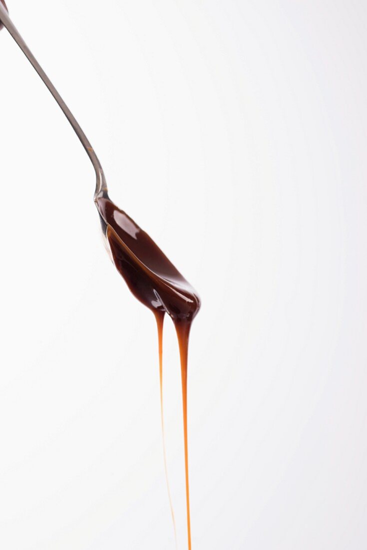 Caramel dripping from a teaspoon