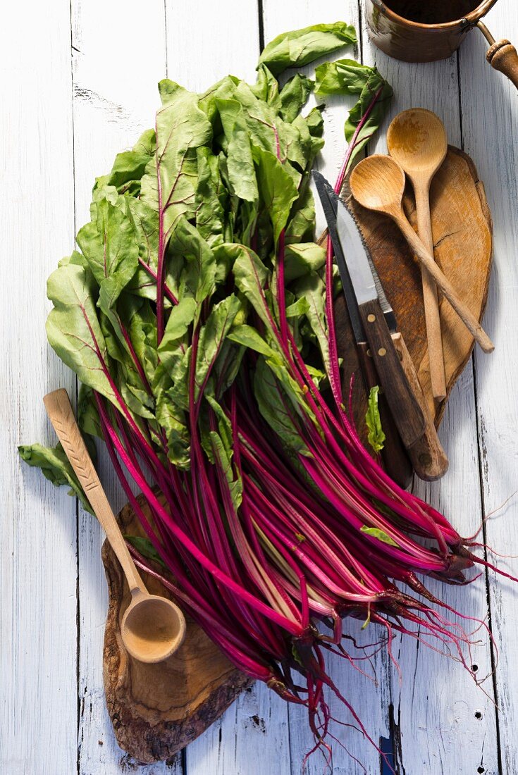 Red chard leaves on a wooden board