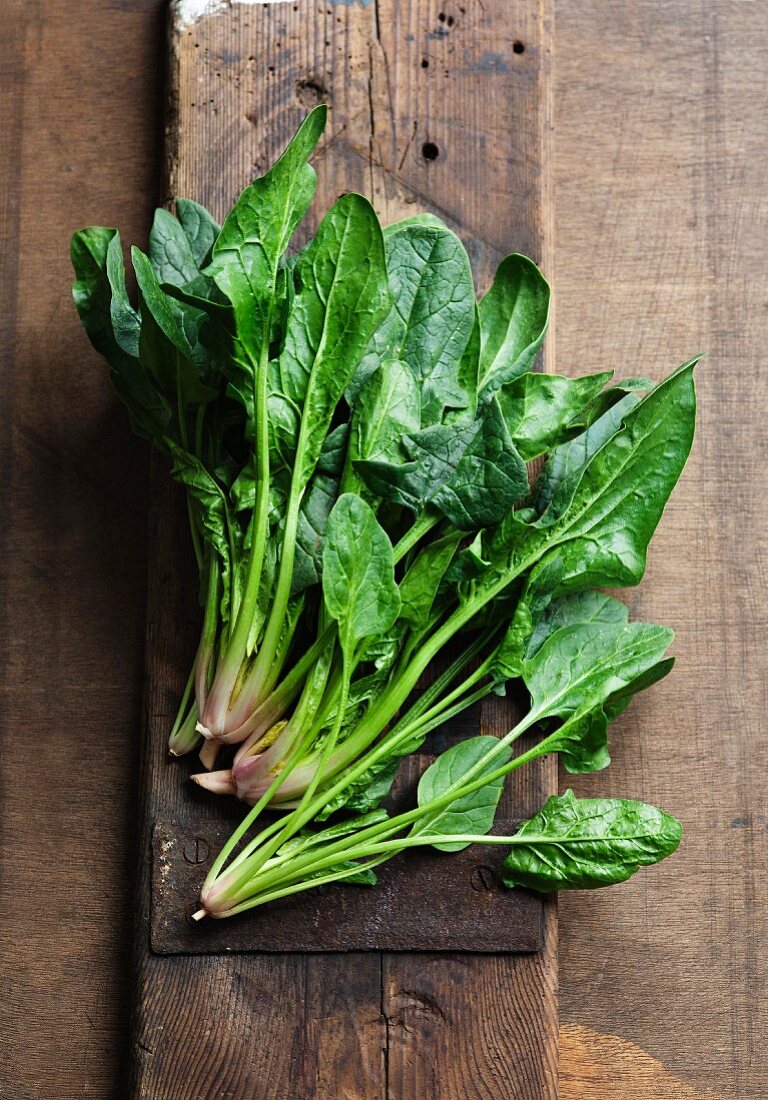 Fresh spinach leaves on a wooden surface