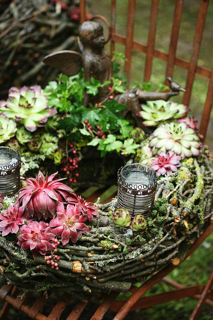 Wreath with house leeks (sempervivum) on vintage metal chair in garden