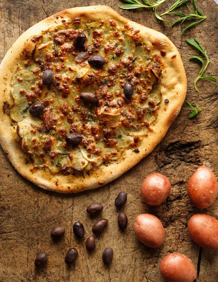 Potato pizza with anchovies and olives
