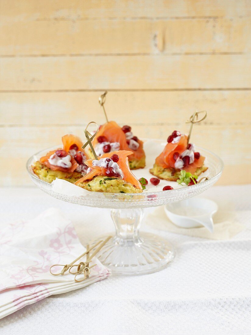 Mini potato cakes topped with salmon and pomegranate seeds