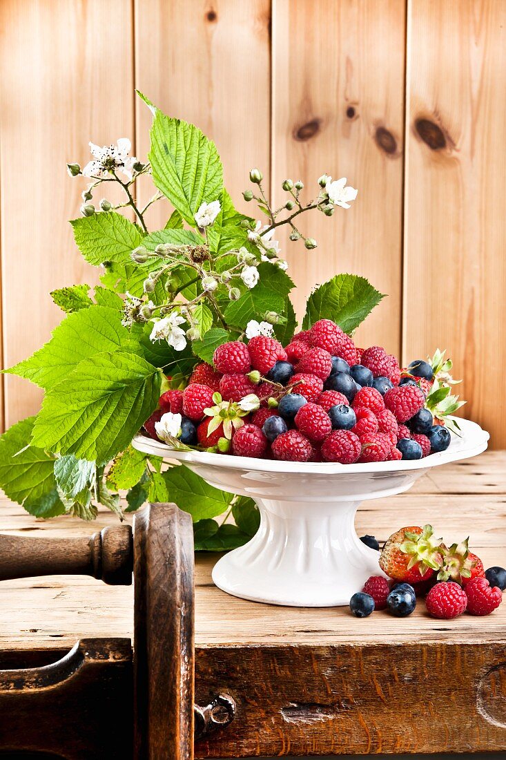 An arrangement of raspberries and blueberries in a bowl