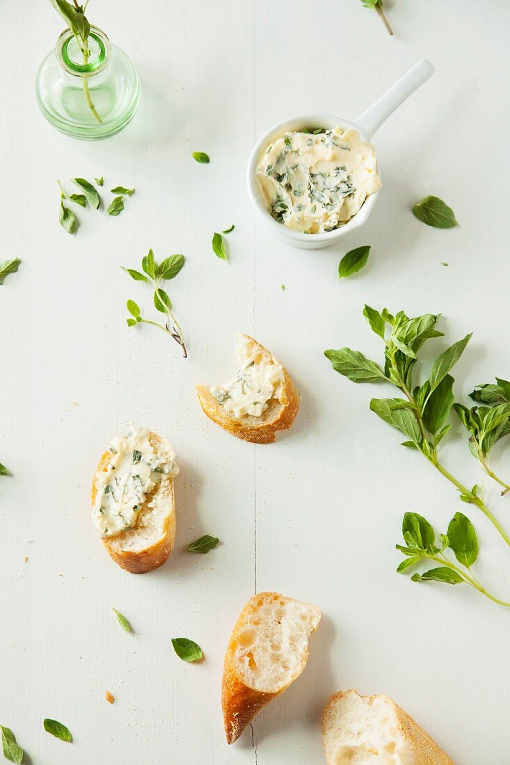 Homemade herb butter and slices of baguette