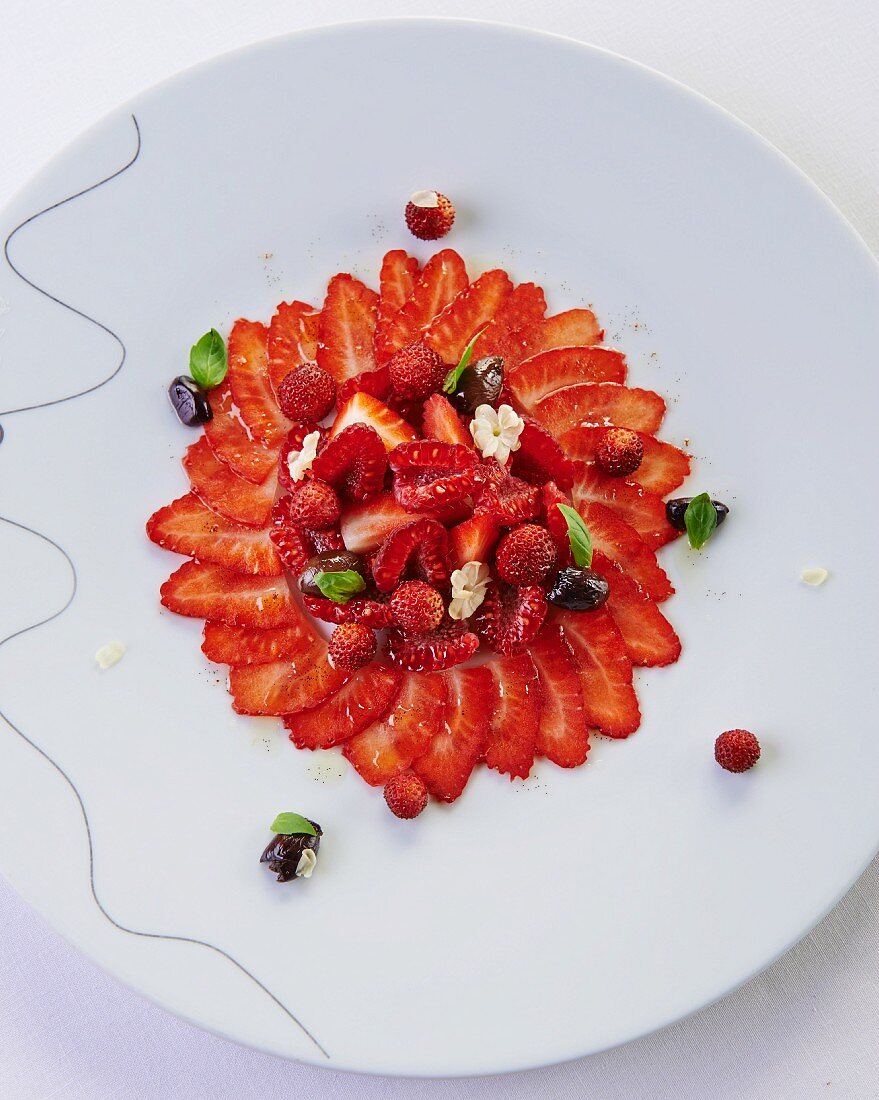 Strawberry carpaccio with wild strawberries