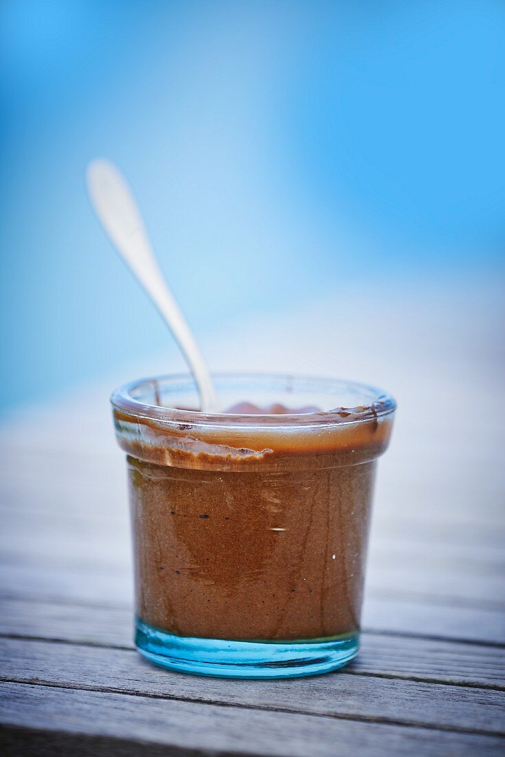Mousse aus chocolat in a jar with a spoon