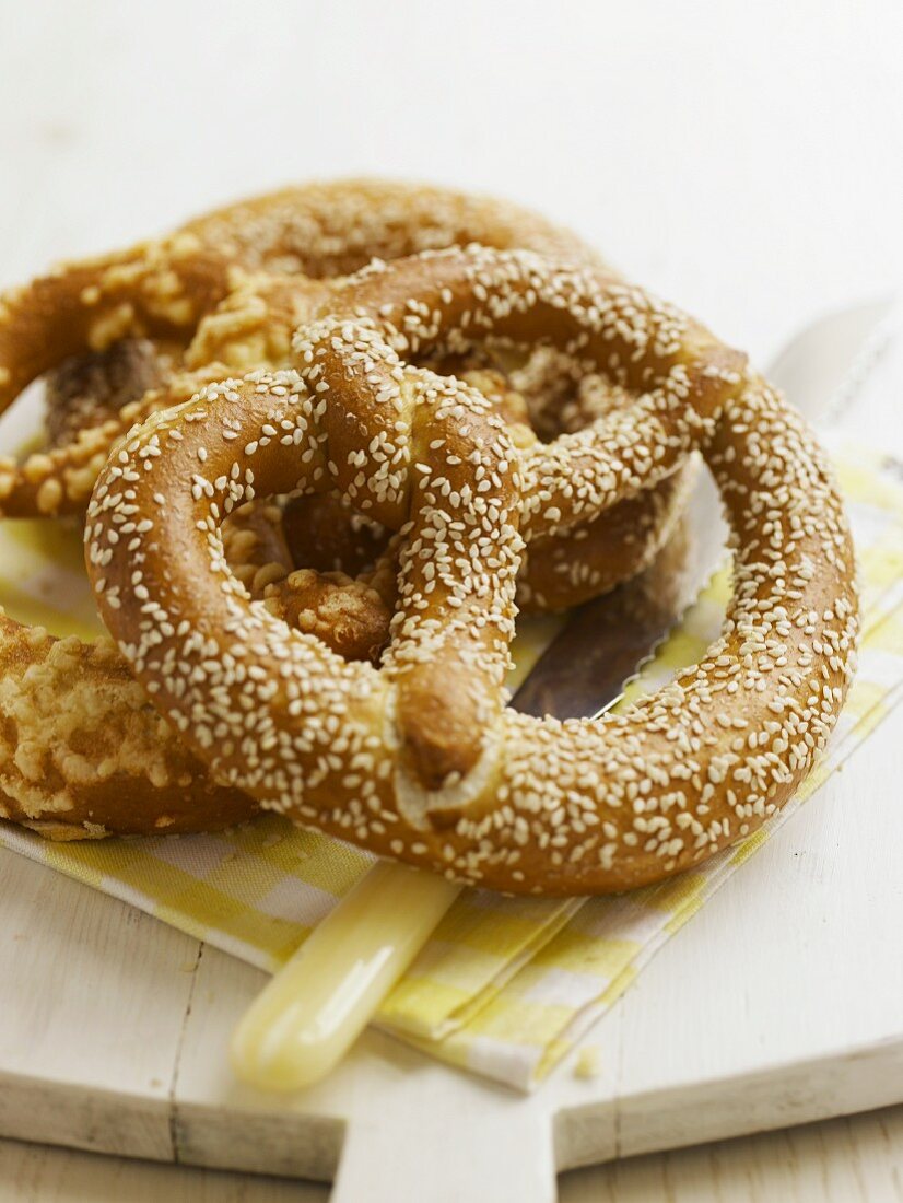 A sesame seed pretzel and a cheese pretzel