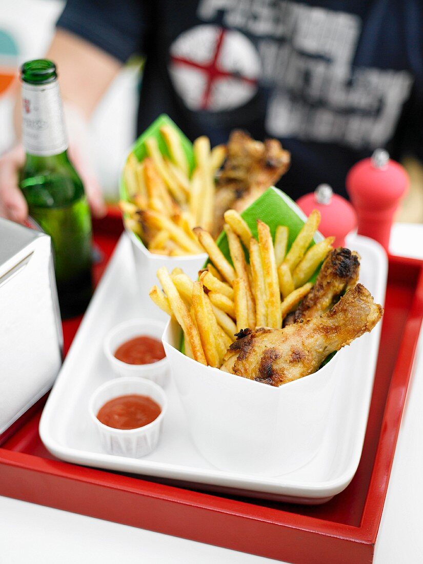 Chicken drumsticks and French fries
