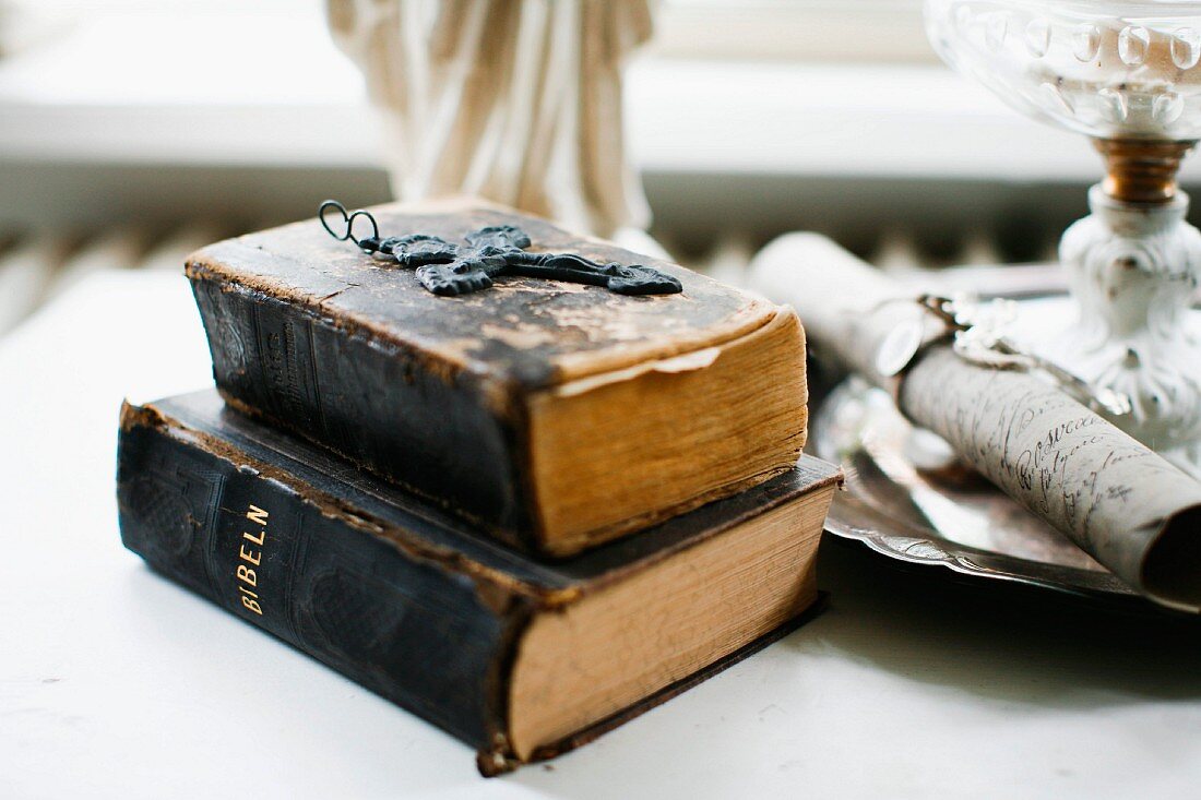 Cross pendant on sacked, antiquarian books