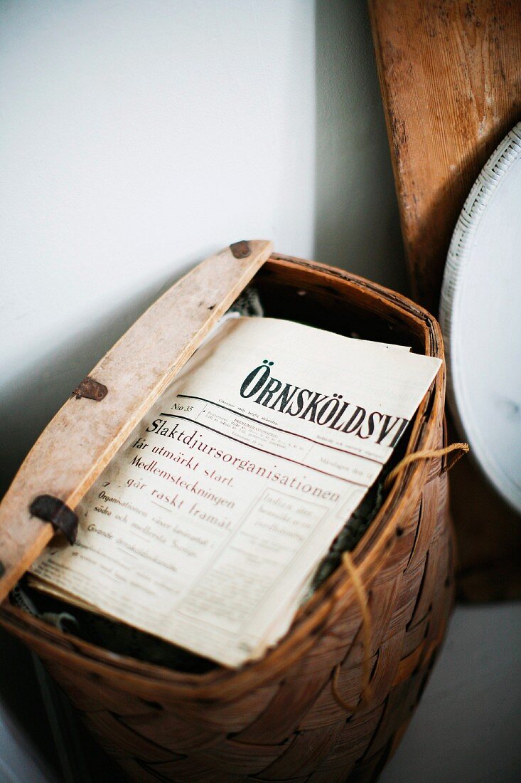 Rustic basket of Swedish newspapers