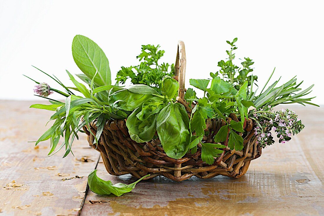 A wicker basket filled with fresh herbs