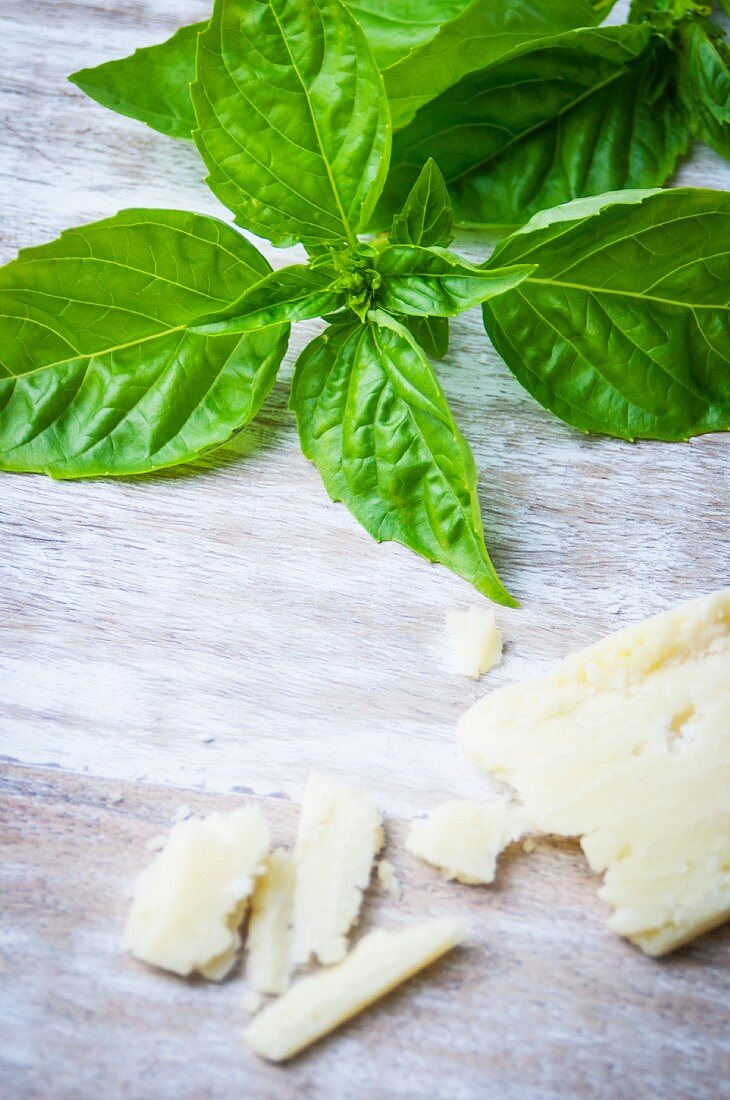 Basil and Parmesan on a wooden surface