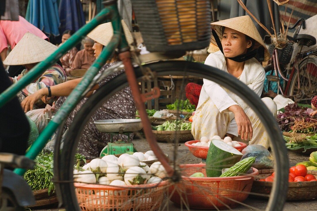 Female market stall holders at a vegetable market in Vietnam