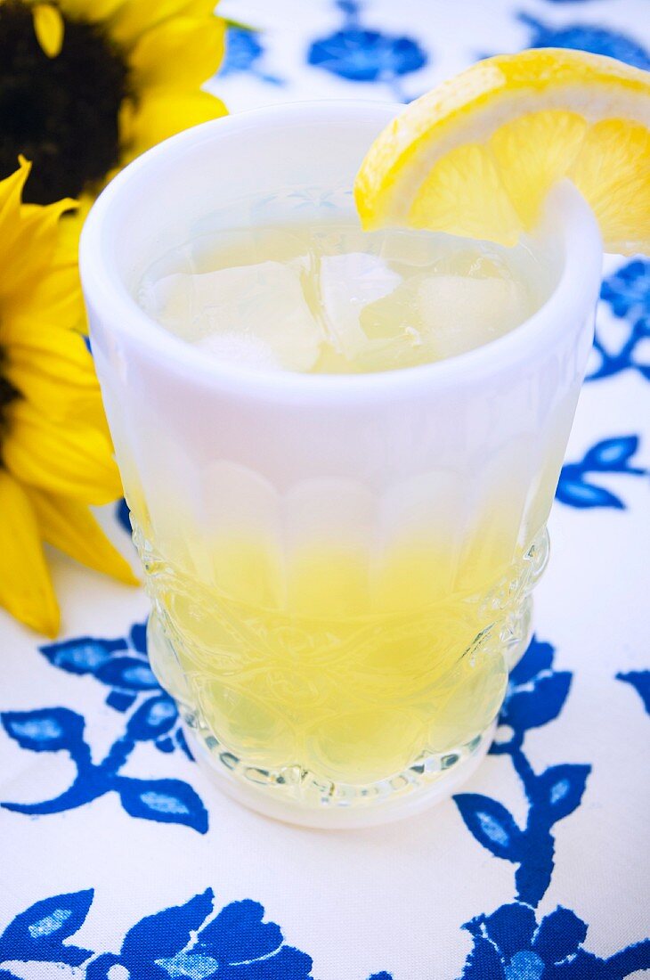 A lemon drink in a thick glass