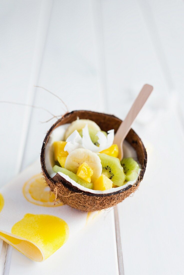 Exotic fruit salad served in a coconut shell