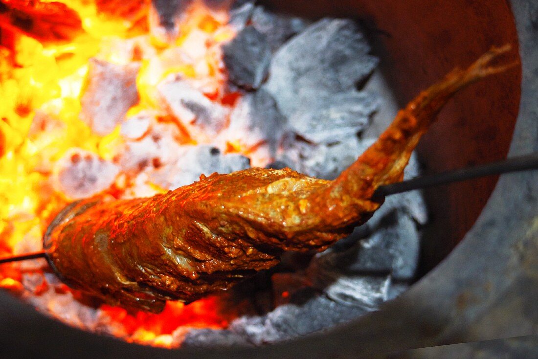 Tandoori fish over glowing coals