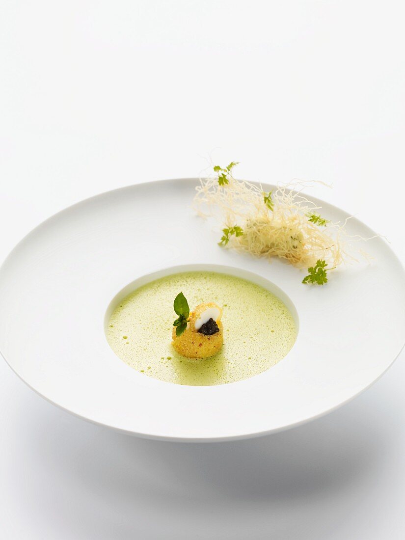 Chervil foam soup with baked quail's eggs and caviar