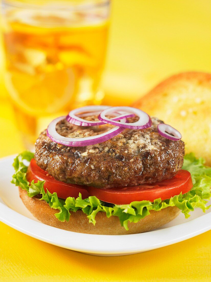 A hamburger with tomatoes and lettuce