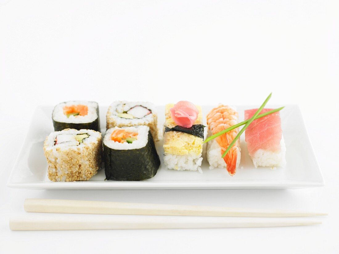 Various types of sushi on a rectangular porcelain plate