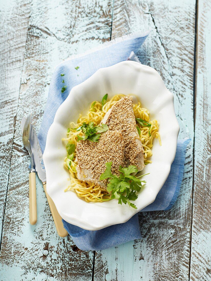 Sesame fish on a bed of oriental noodles