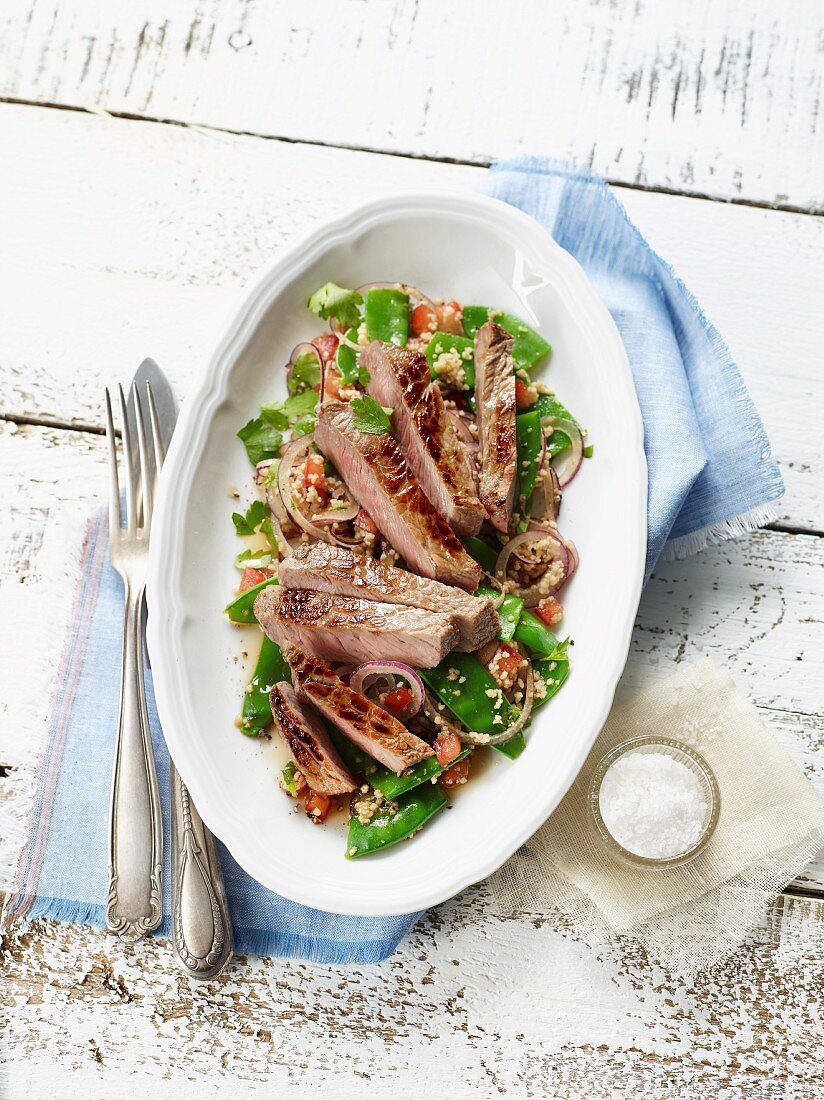 Salad with vegetables, rump steak and couscous