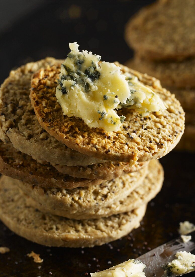 A stack of poppy seed and oat biscuits with Stilton