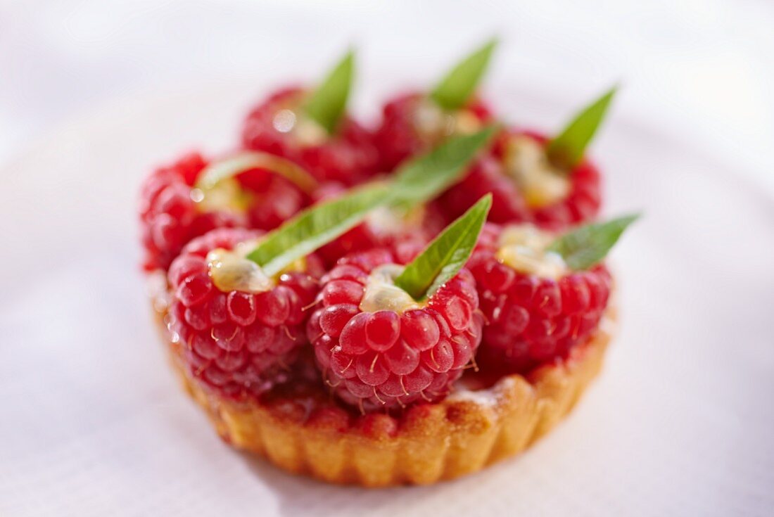 A raspberry tartlet topped with stuffed raspberries