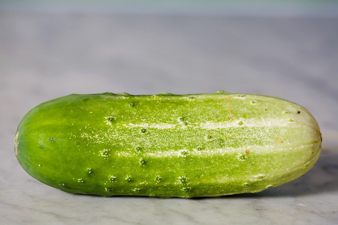 A gherkin on a marble surface