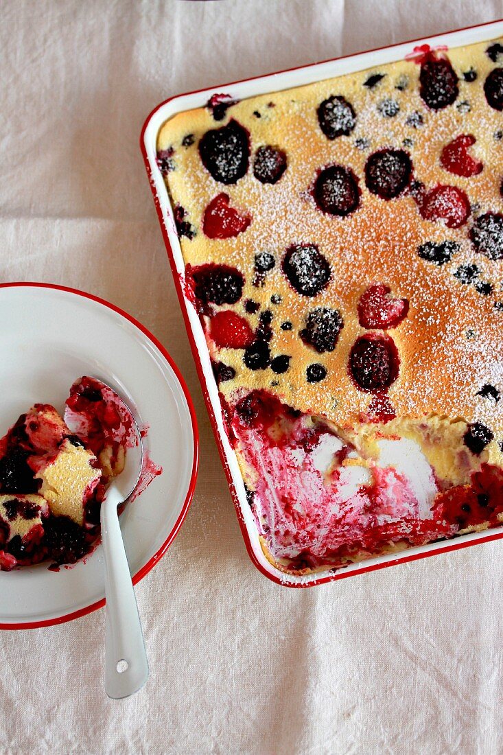 Berry pudding in a baking dish and on a plate