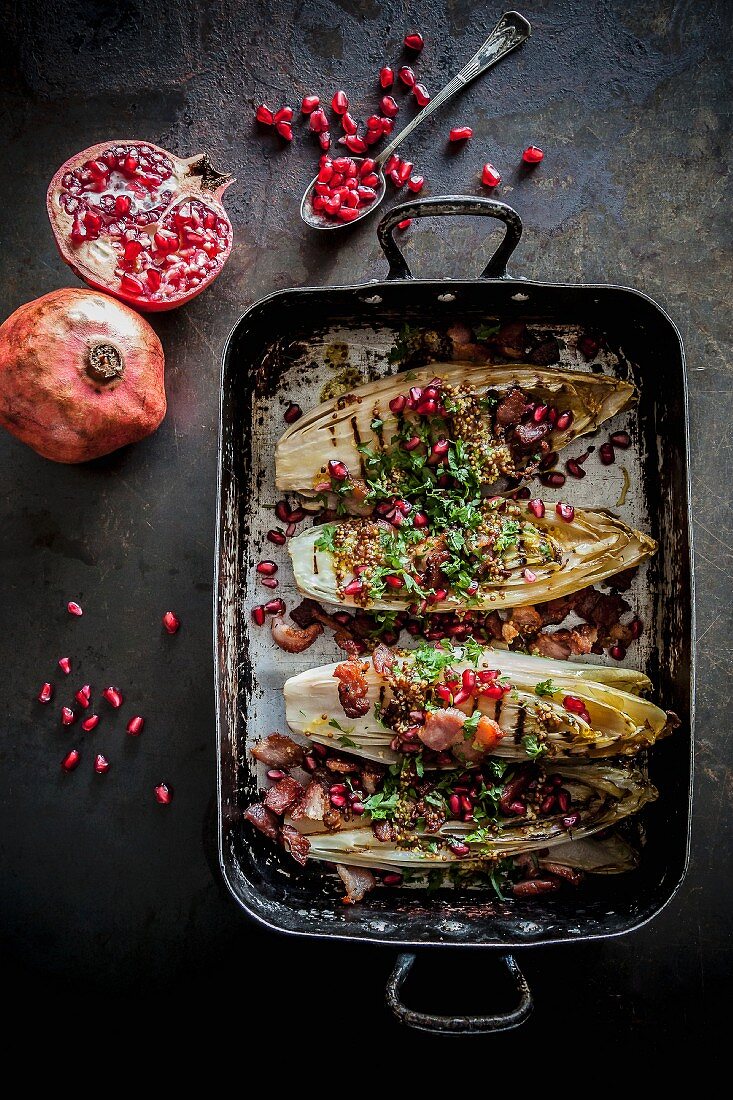 Grilled chicory with pomegranate seeds and pancetta