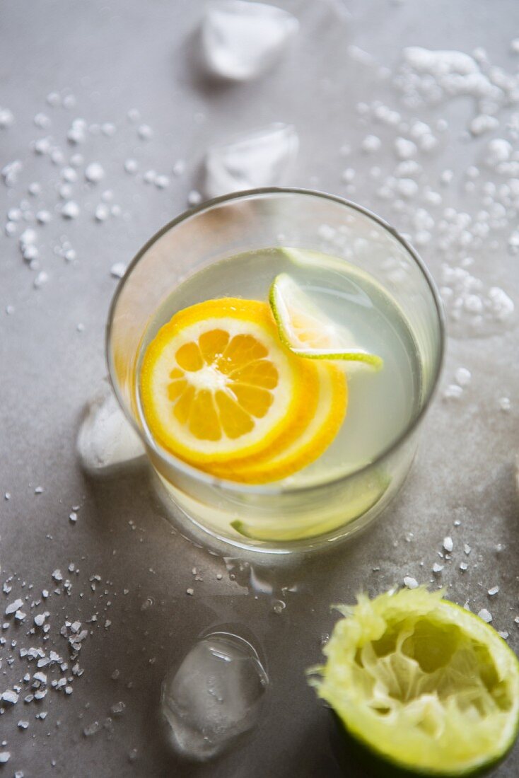 A glass of refreshing citrus water with slices of fruit