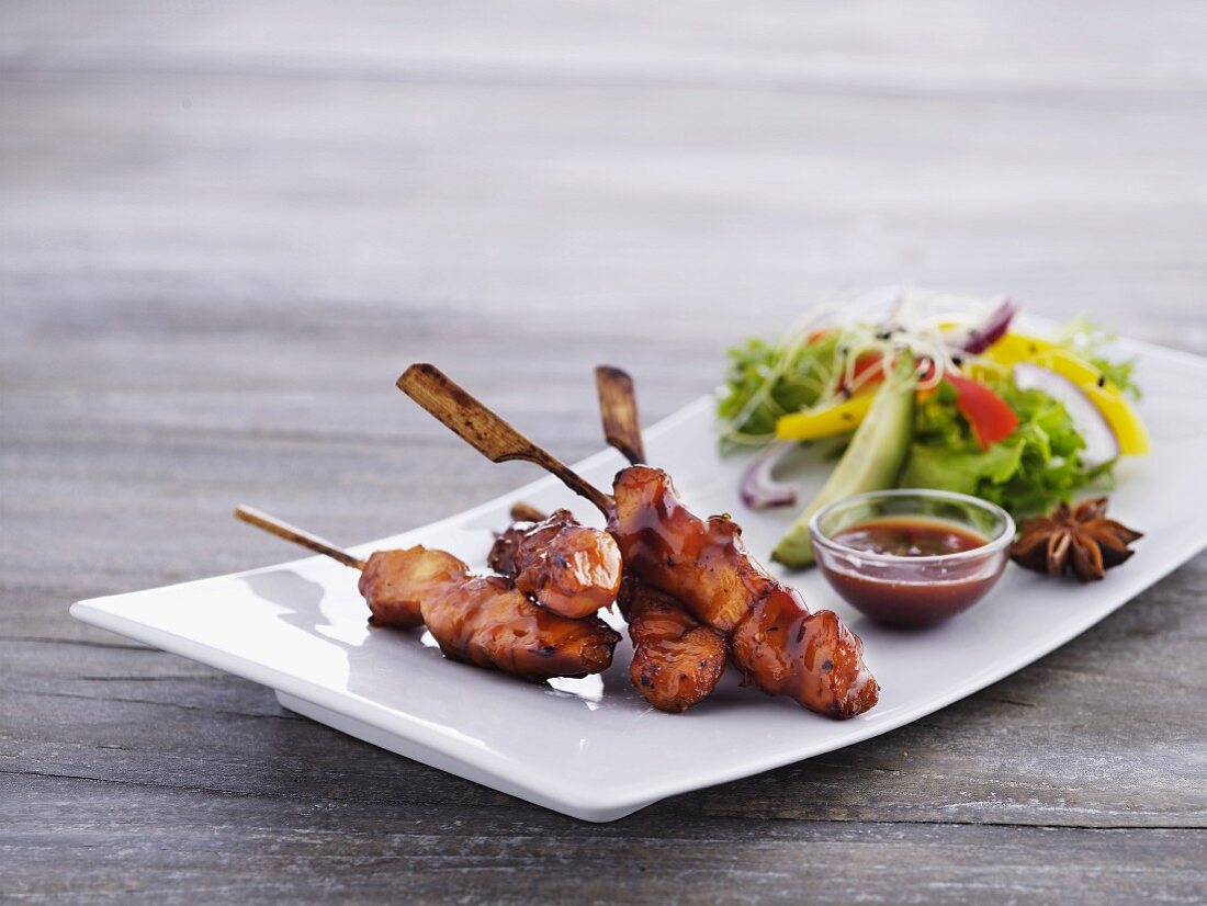 Chicken skewers with a spicy sauce and lettuce