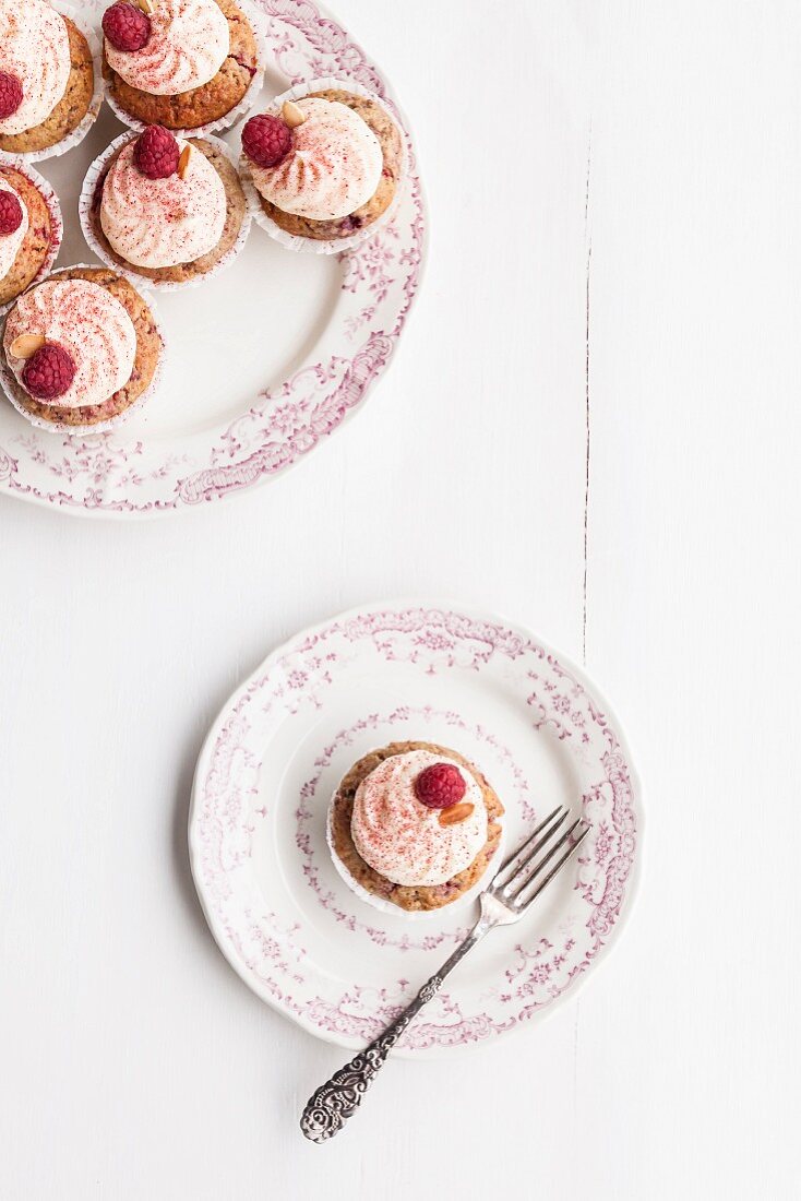 Raspberry and almond muffins decorated with buttercream and dried raspberry powder