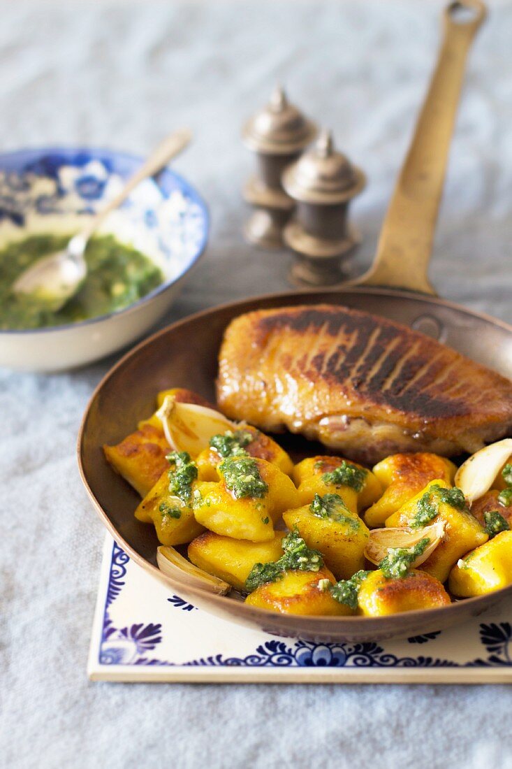 Fried duck breast with pumpkin gnocchi and green mint sauce