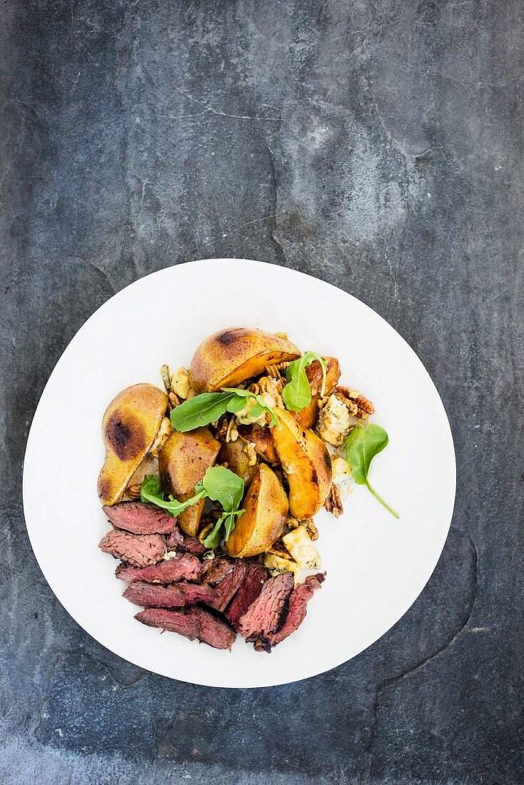 Marinated ostrich fillet with a pear and gorgonzola salad