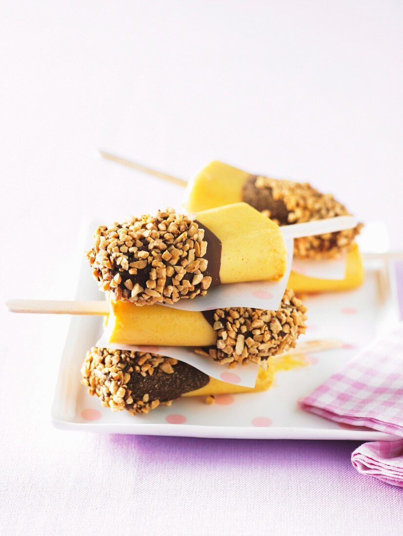 Chocolate-dipped mango ice cream sticks