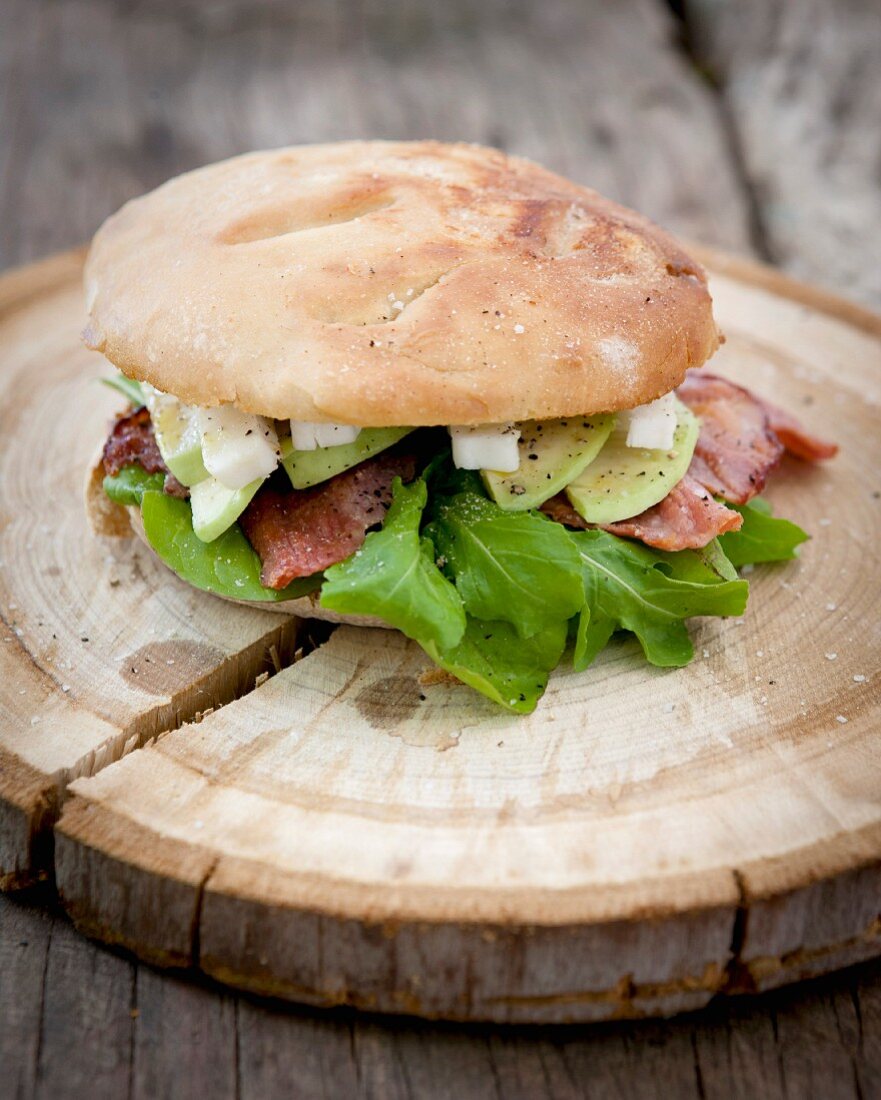 Panini sandwich with bacon, rocket and goat's feta