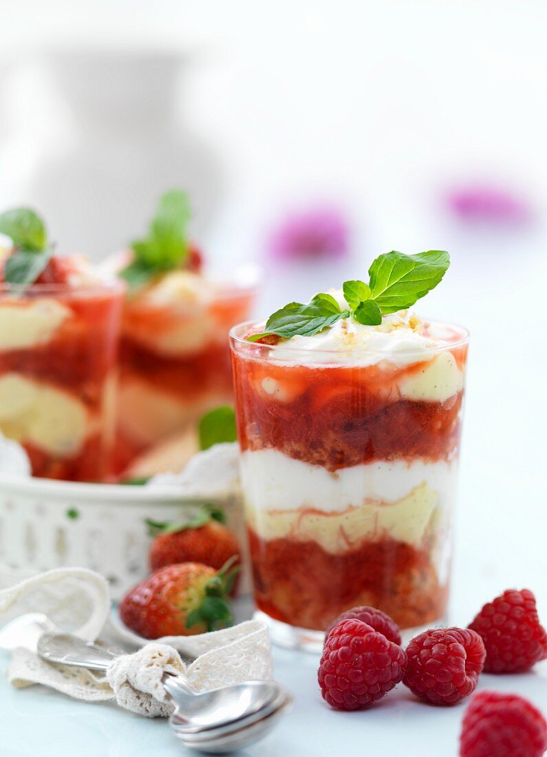 Layered desserts with rhubarb and strawberry compote, vanilla cream, meringue, cream and sponge cake