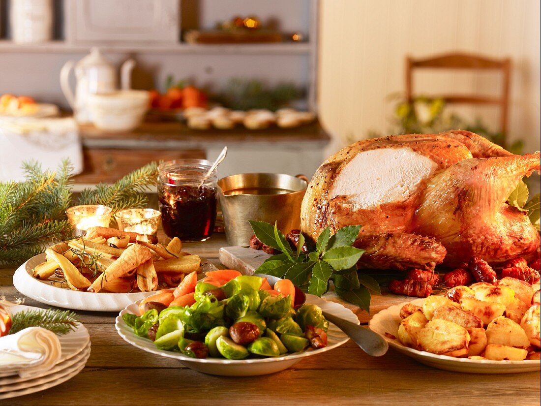 Traditional, country house-style Christmas dinner with a carved turkey and accompaniments