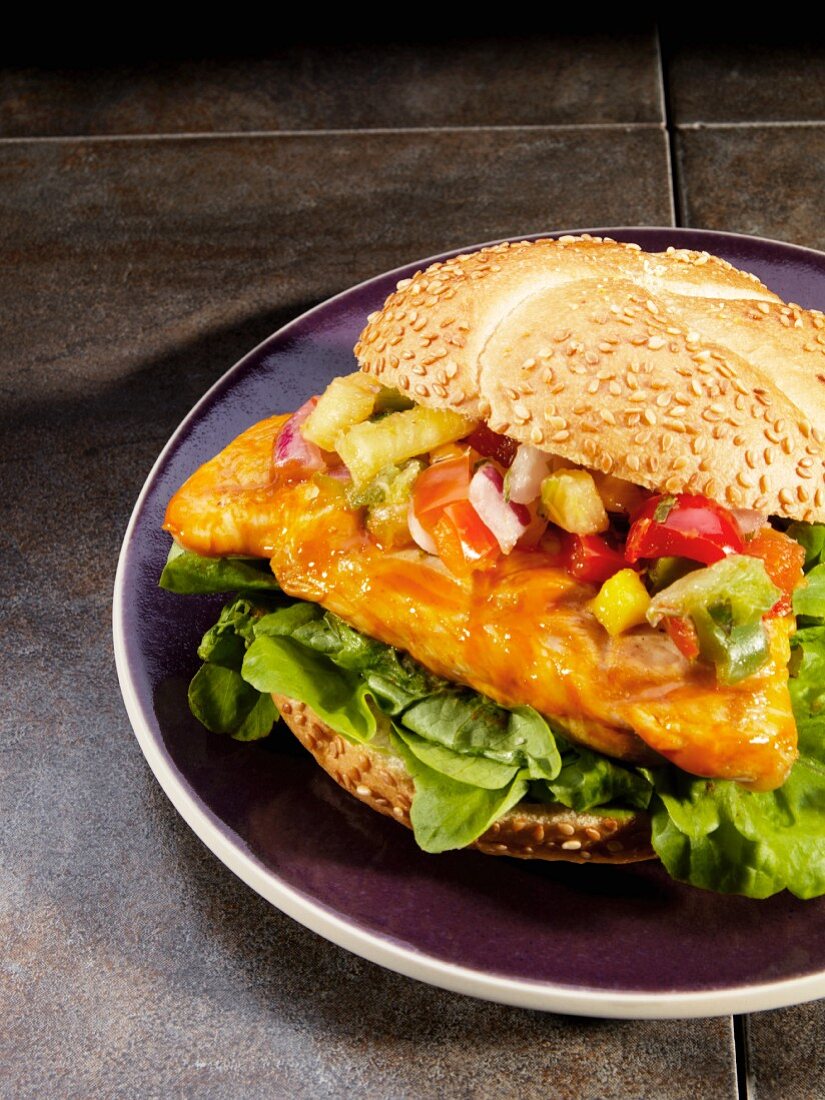 Grilled spicy chicken breast sandwich with mango and pineapple salsa