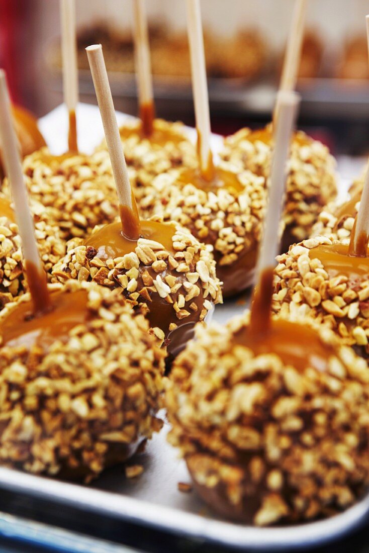 Toffee apples covered in chopped nuts