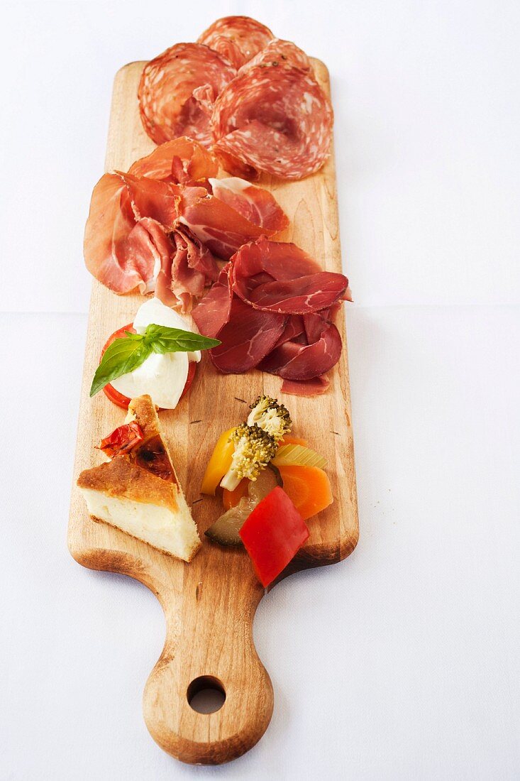 A selection of cold cuts with cheese and vegetables