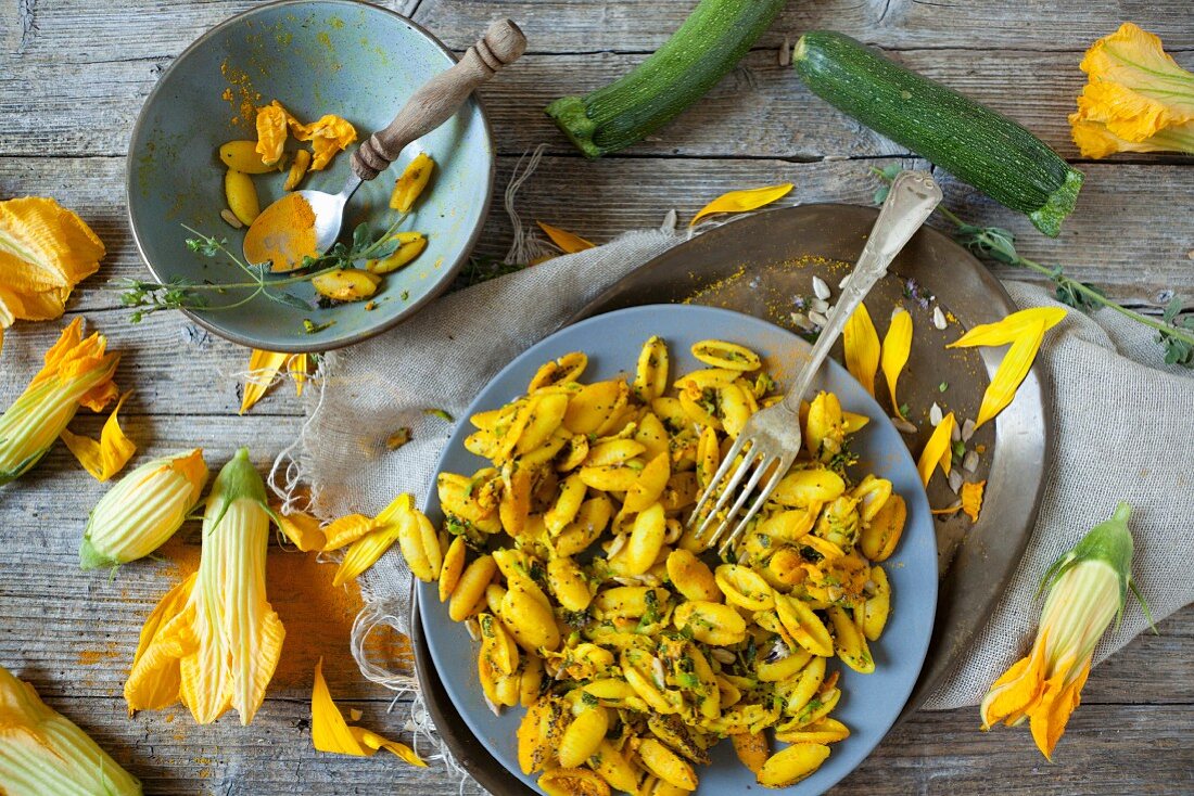 Shell pasta with courgette flowers, poppy seeds and sunflower seeds