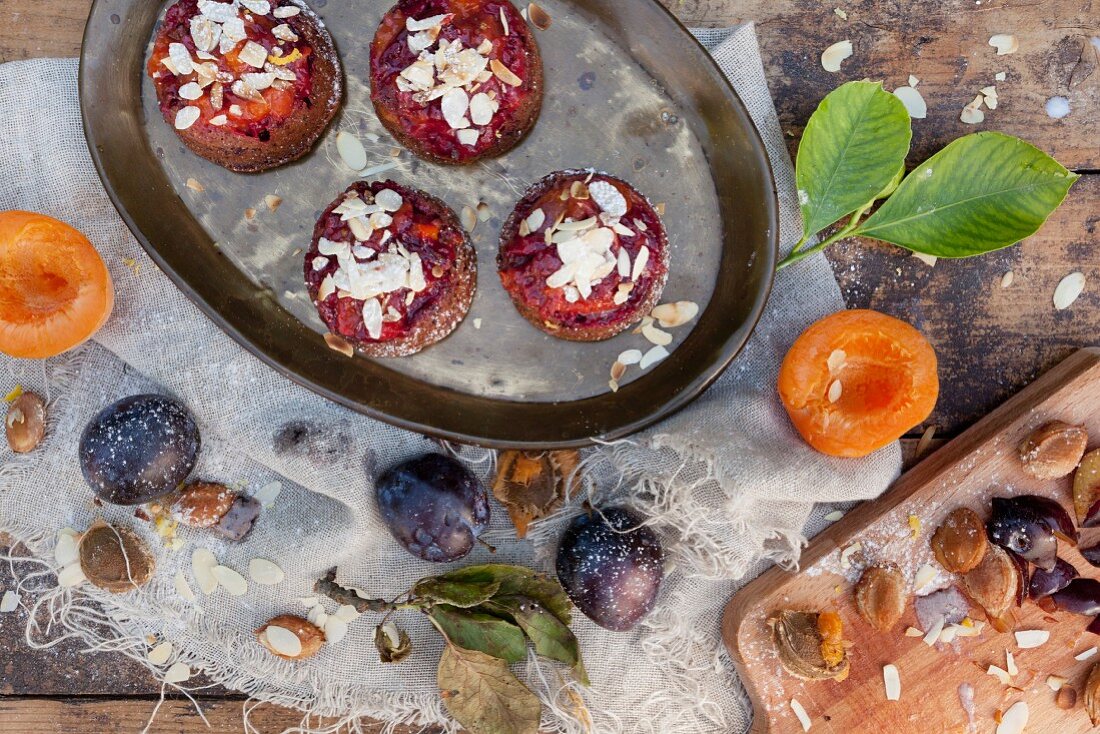 Vegan cupcakes with apricots and plums on a rustic table