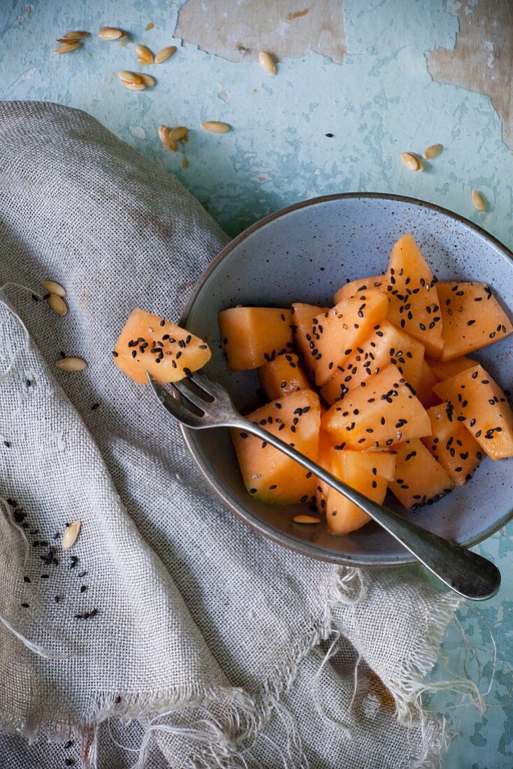 Pieces of melon with black sesame seeds