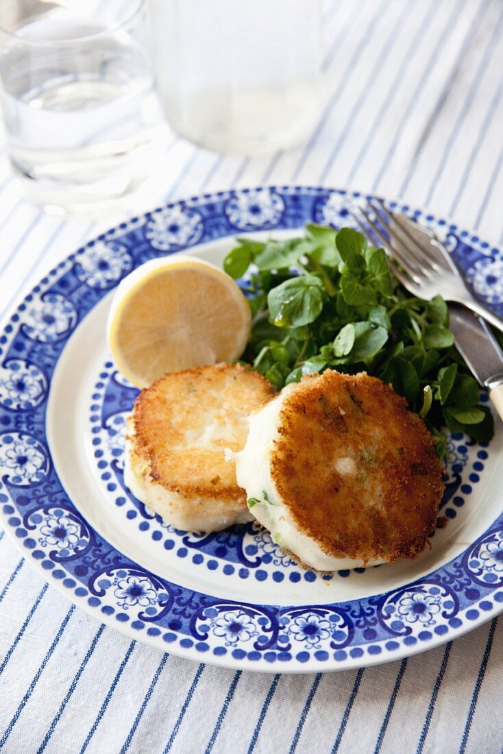 Smoked cod and spring onion fishcakes with watercress and lemon