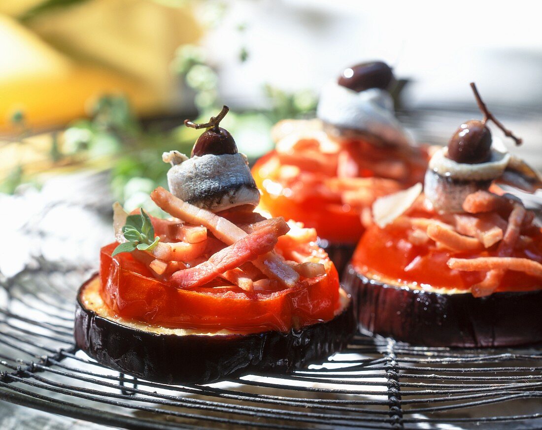 Aubergines with tomatoes, bacon, anchovies and olives