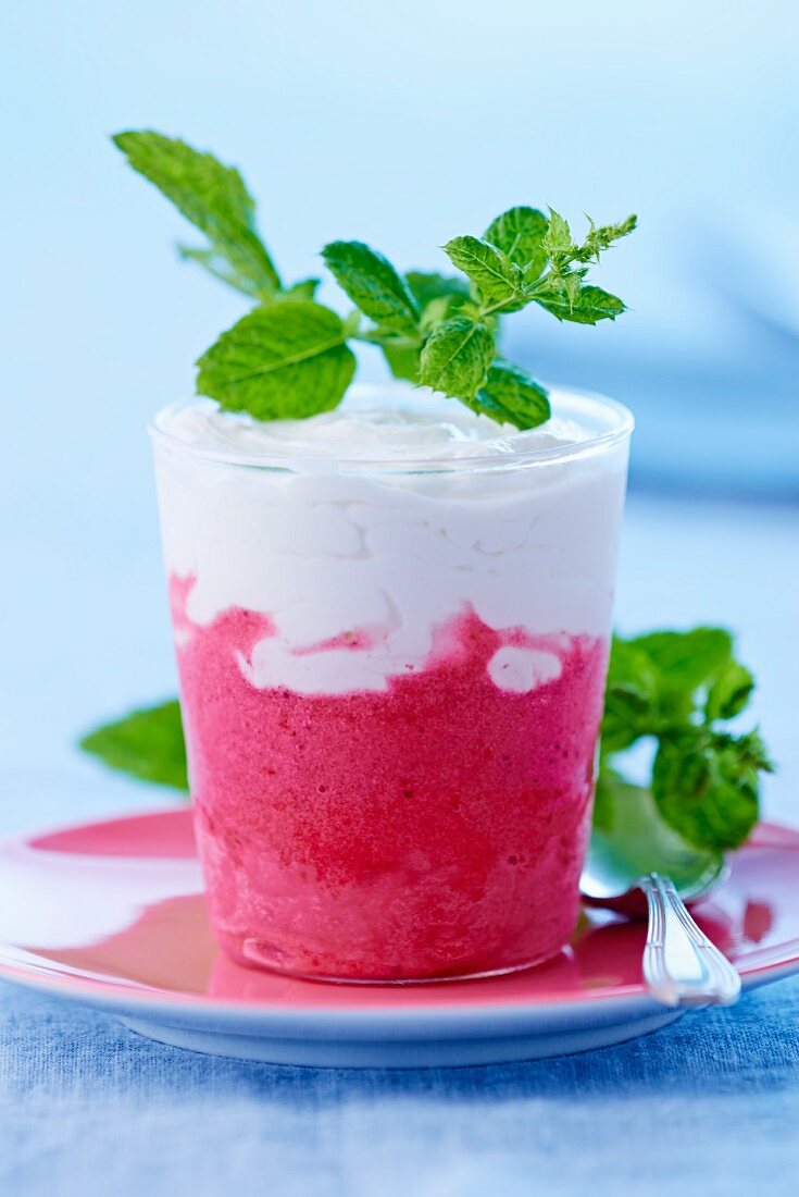 Strawberry ice cream garnished with a sprig of mint